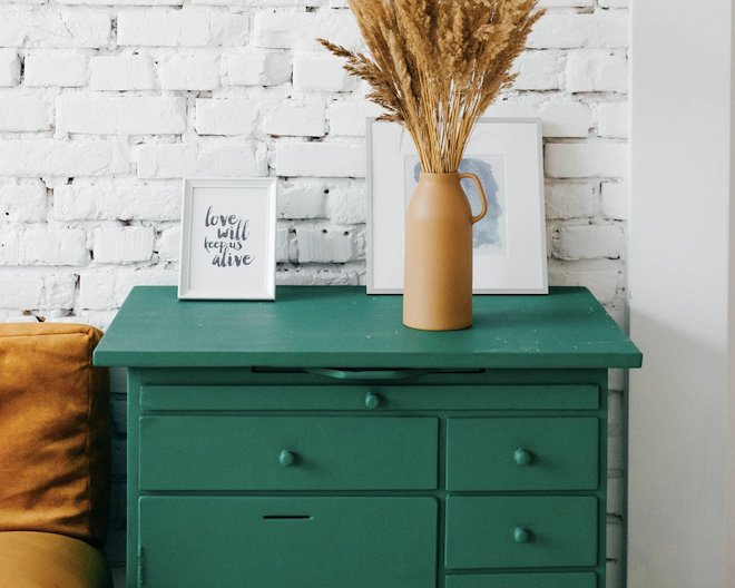 A room with a green dresser